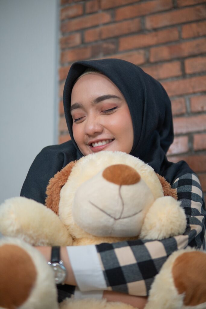 young lady is hugging stuffed-animal