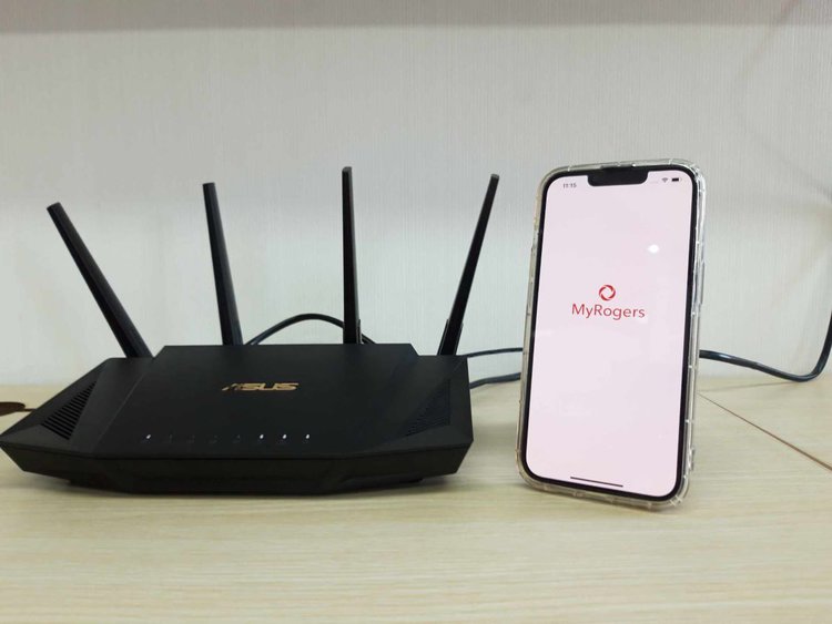 Rogers on iPhone 13 with Asus router on a table