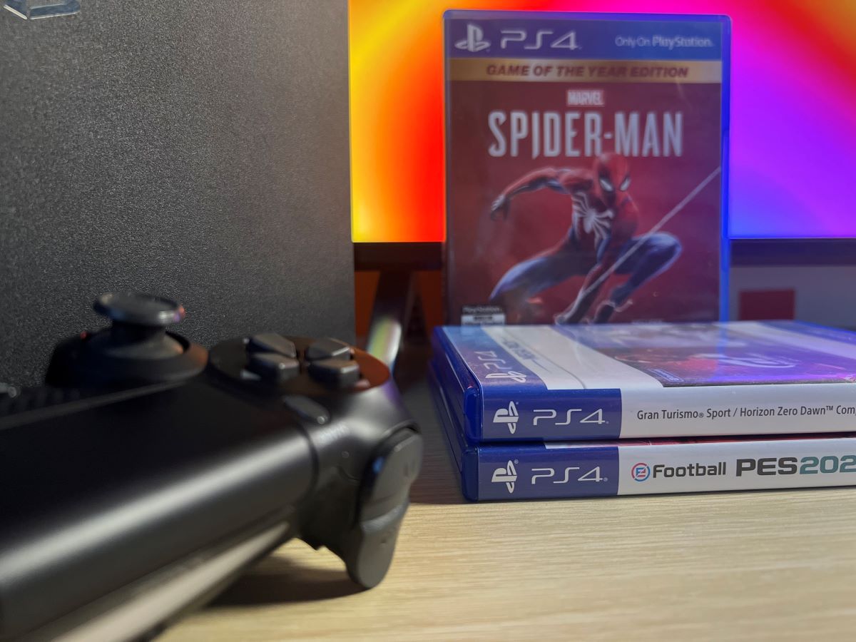 The Spider-Man game with eFootball 2023 and Horizon Zero Dawn disc game with the PS4 controller and console along side