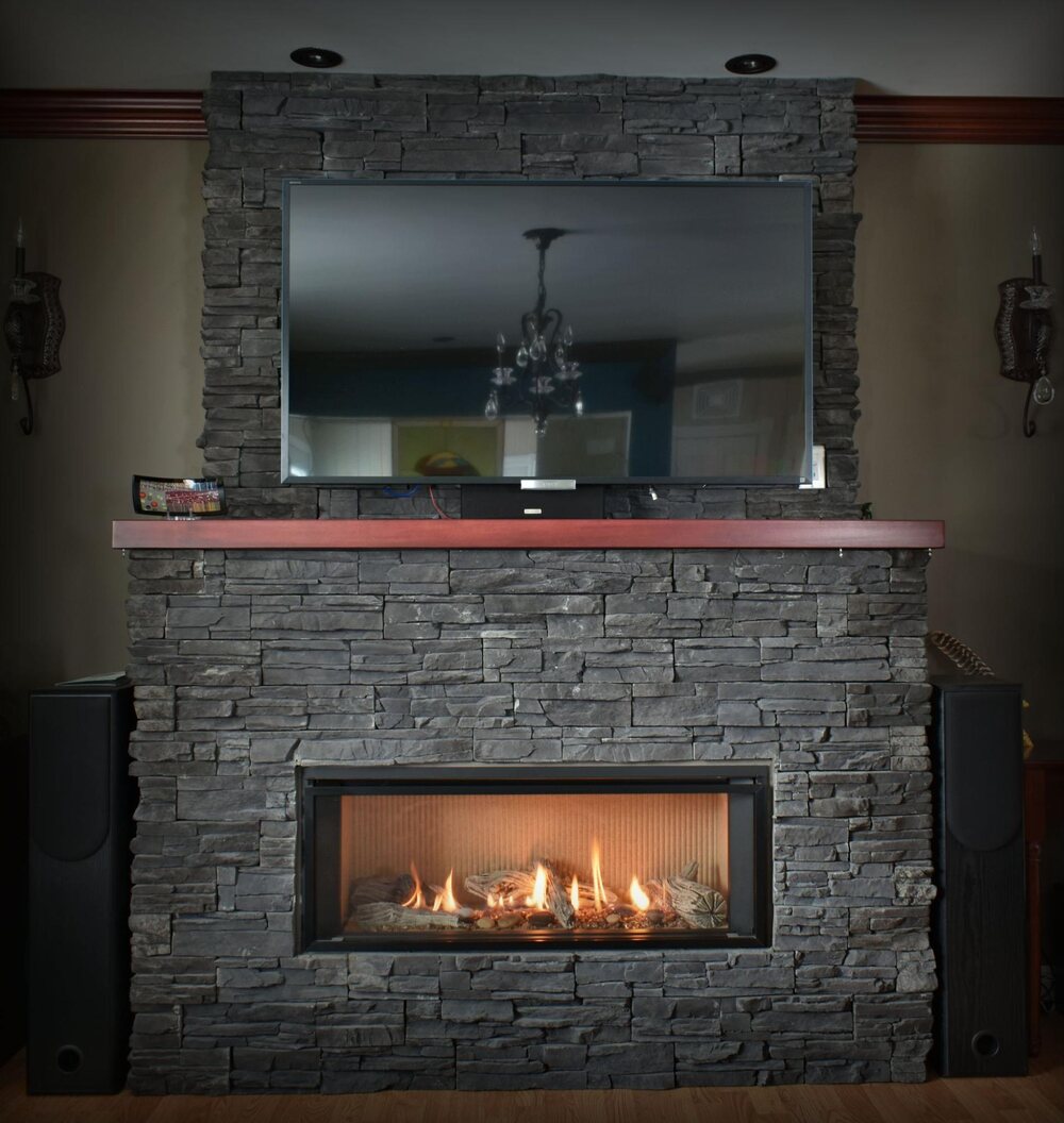 TV mounted above a fire place