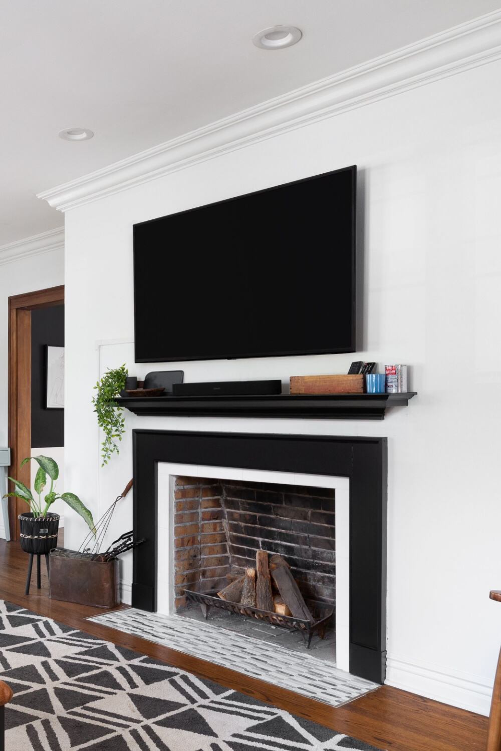 mounted tv above a shelf and a fireplace