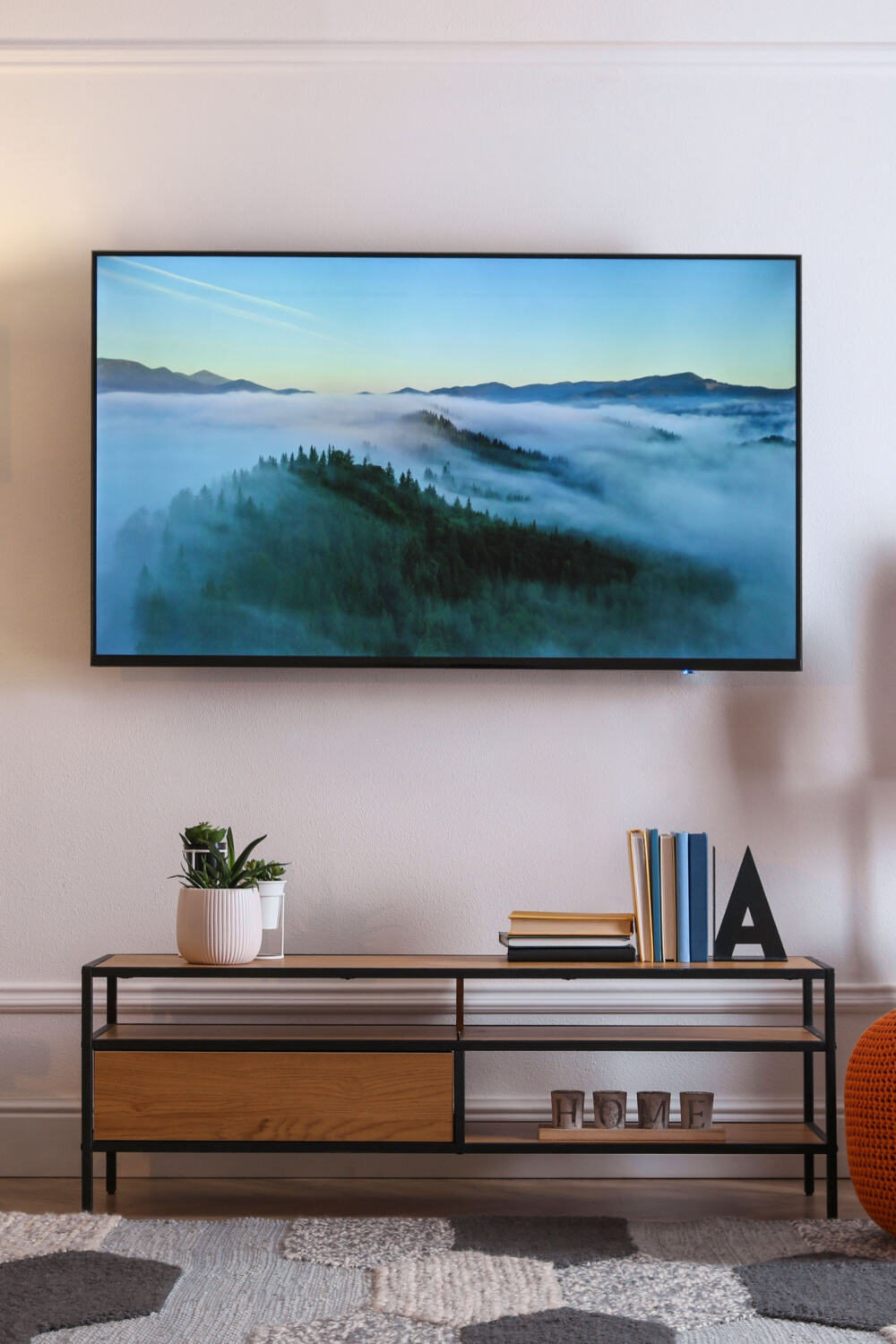 mounted tv above a shelf