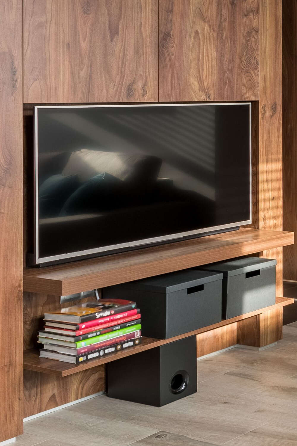 mounted tv above two floating shelves