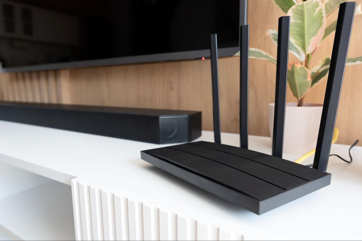 mounted tv with a soundbar and a wifi router