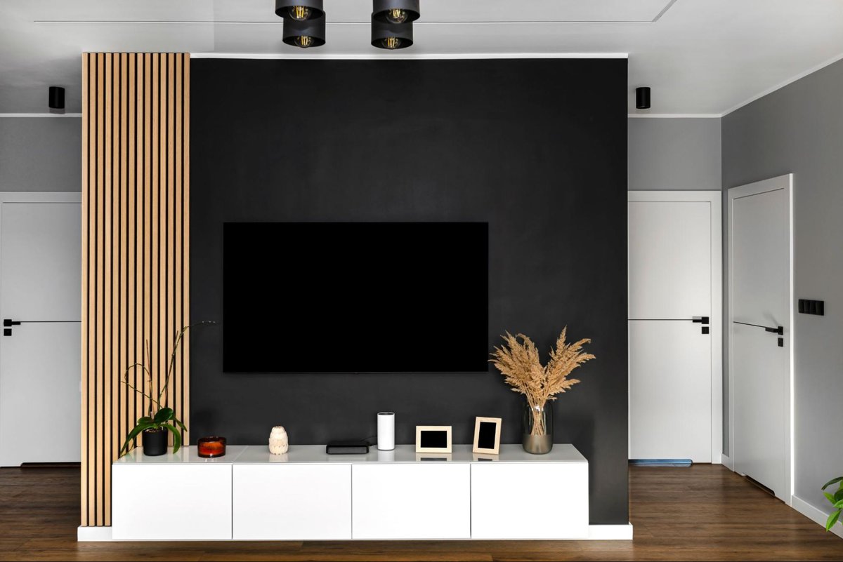 TV mounted on the wall above a white floating stand
