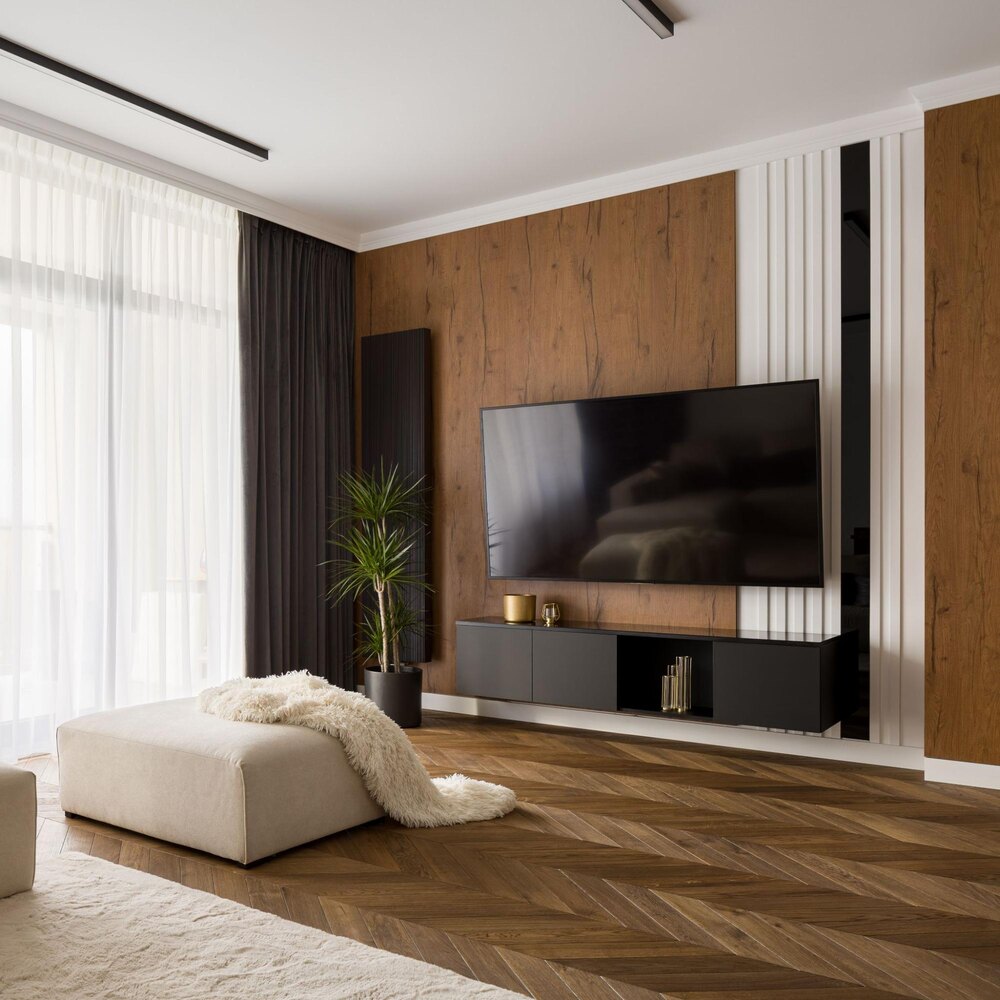 TV mounted above a black floating tv stand 