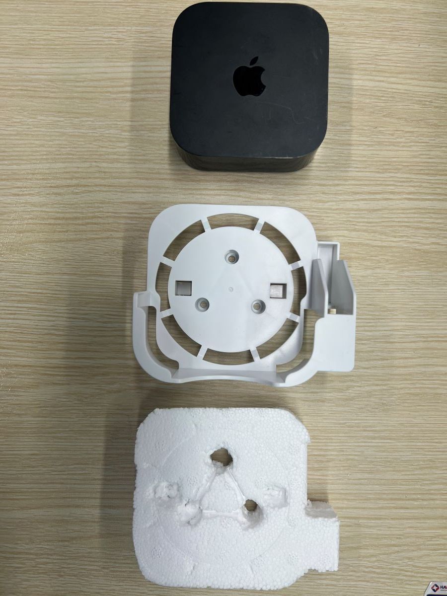 Apple TV, the Apple mount and the foam is cut to the shape of the Apple TV mount