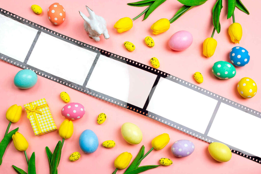 Easter decorations with a frame in the form of a film tape on pink background