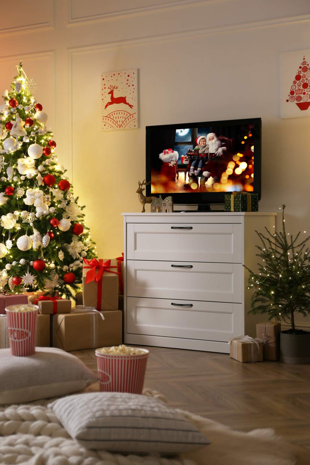 TV on a stand and next to a christmas tree