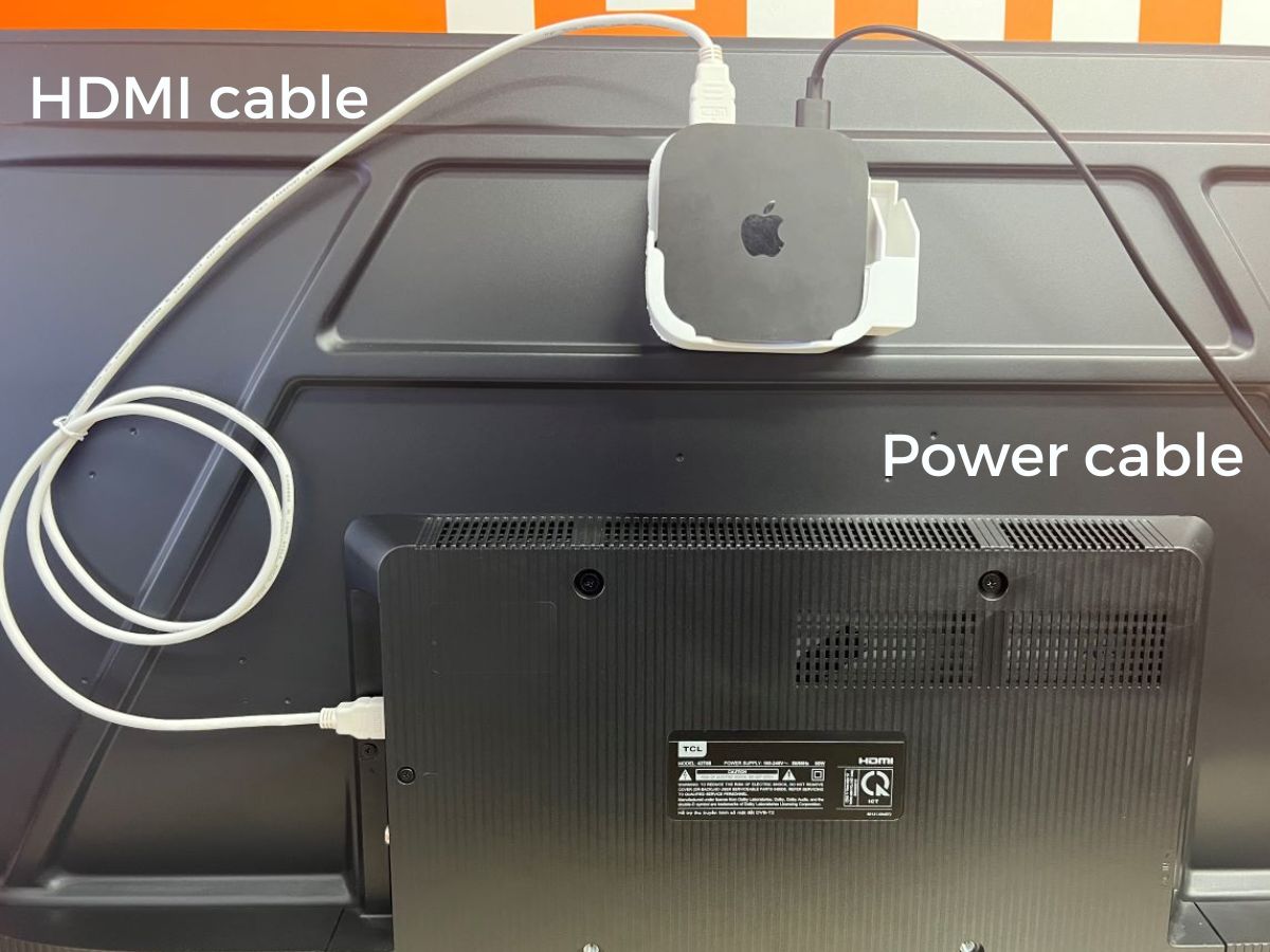 The Apple TV is stick at the back of the TCL TV with the HDMI and power cable are plugged