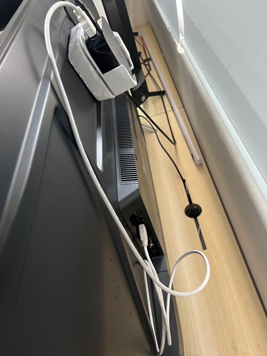 The HDMI cable from the Apple TV box is plugged to the TCL TV