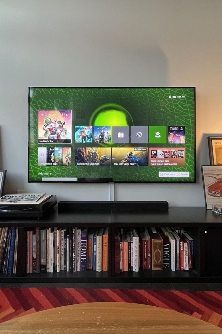 books under a mounted tv