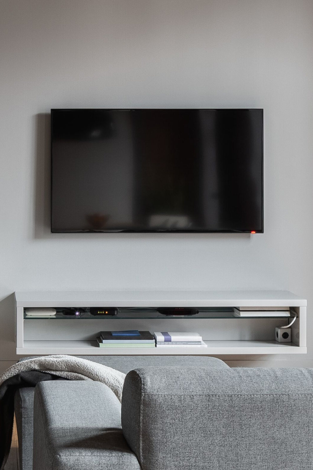 TV mounted above a shelf