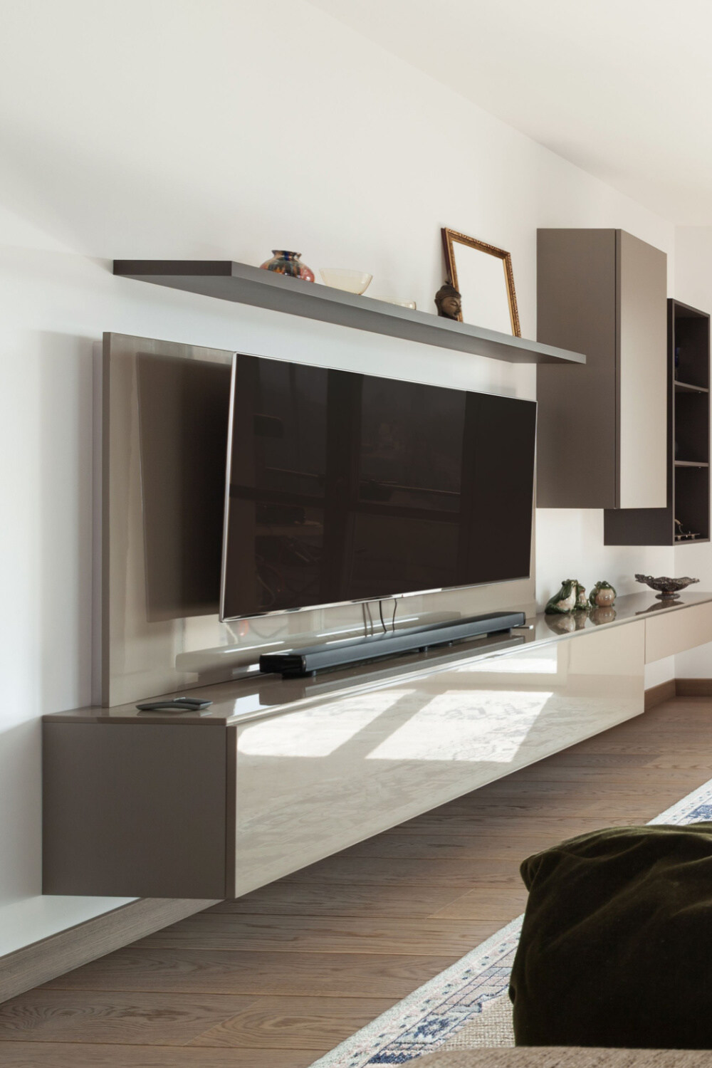 mounted tv above a floating tv stand