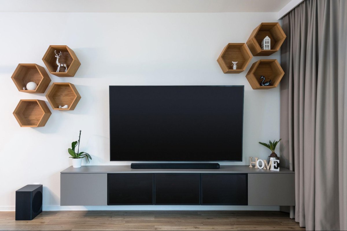 mounted tv above a soundbar and a floating tv stand