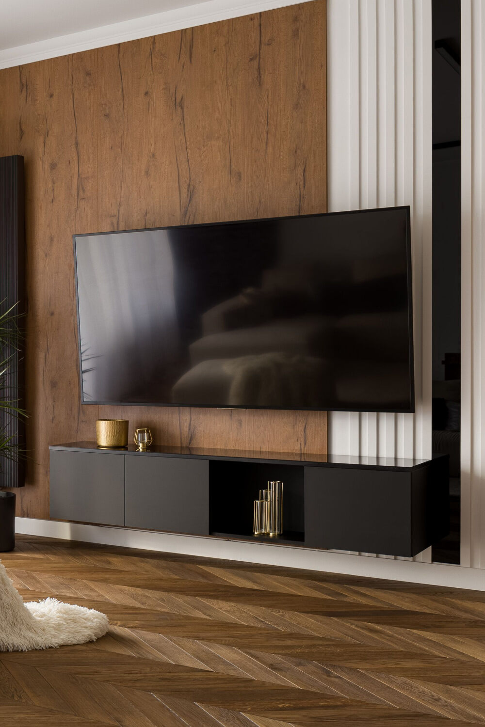 mounted tv above a black floating stand
