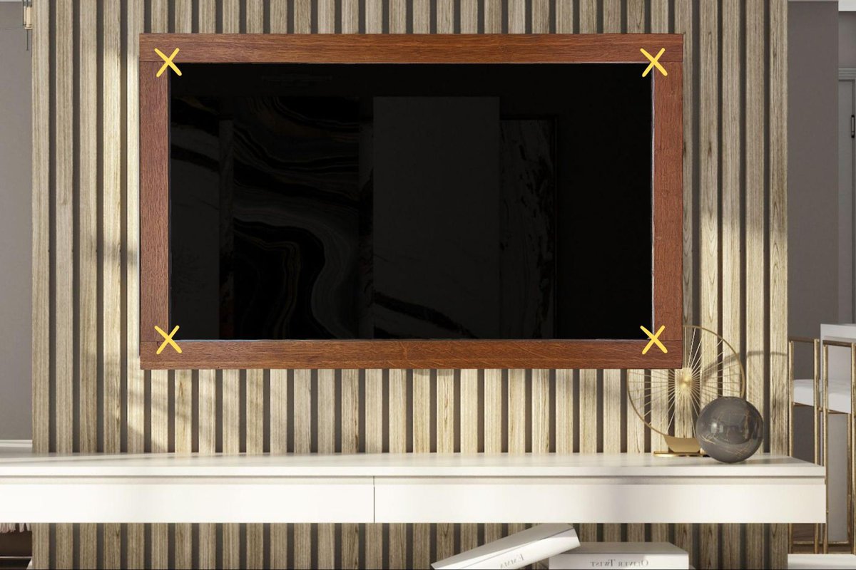 mounted tv with a frame above a shelf