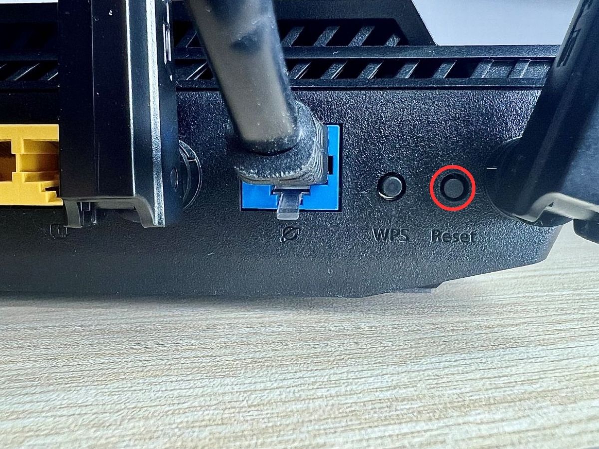 reset button on a router is highlighted