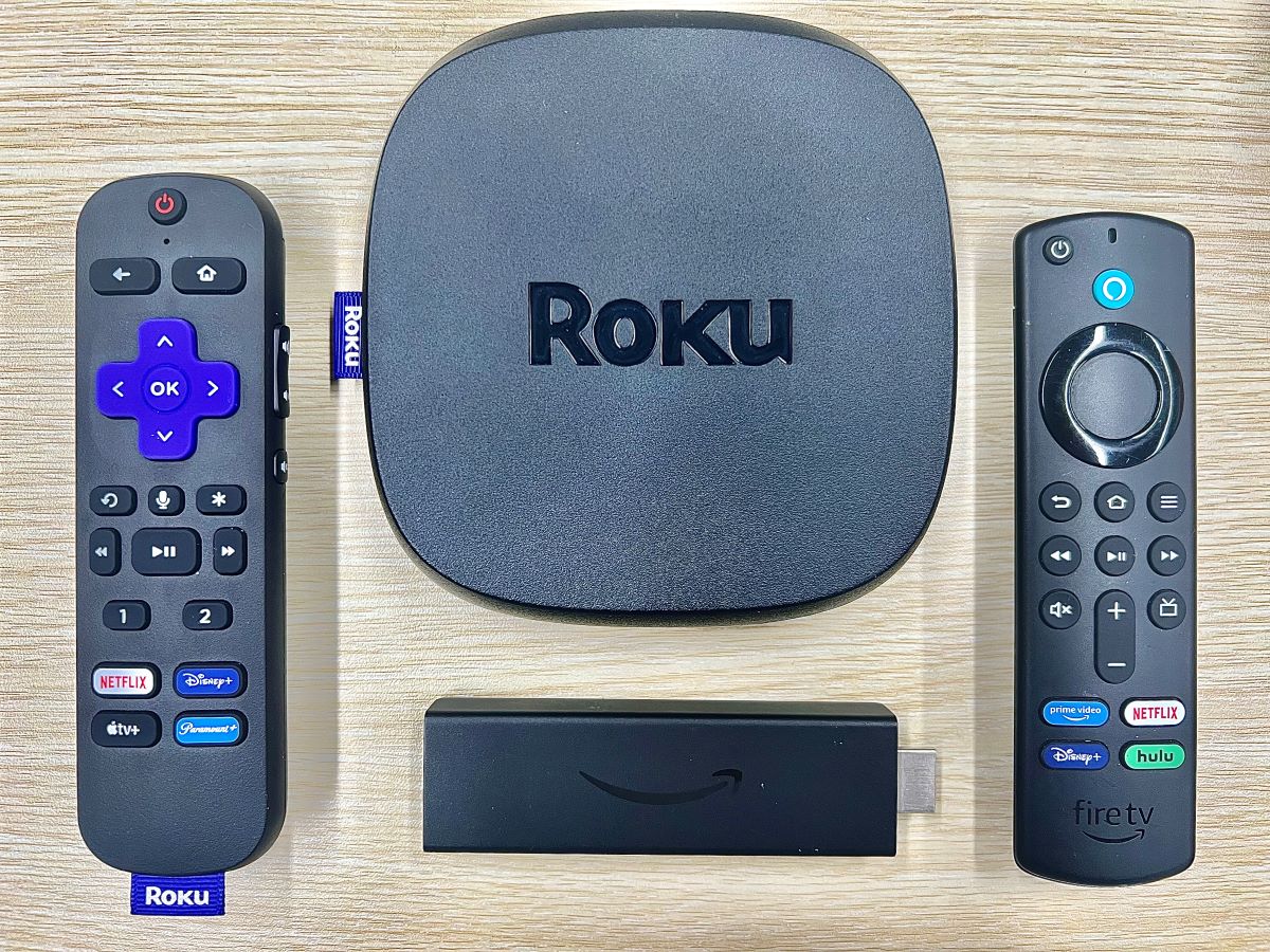 roku ultra, fire stick and their remotes on a table