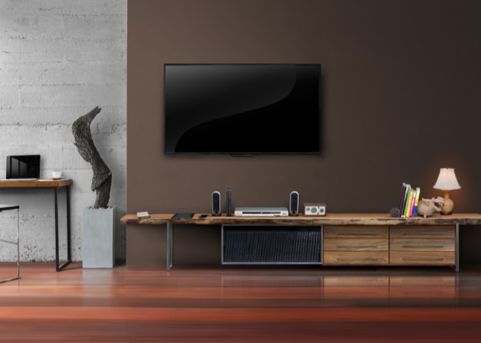 TV stand in the living room with dark wall back drop