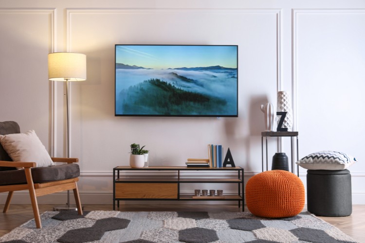 couch, TV stand, and TV in the with multi color in modern Living room